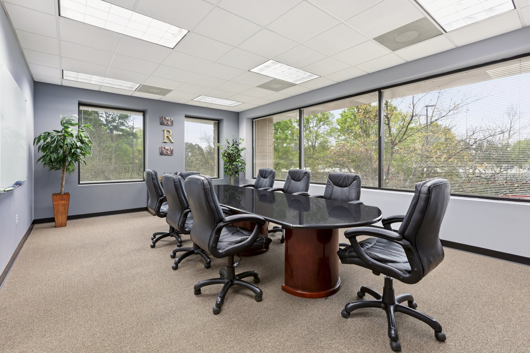 Conference room at Roswell Office Suites with a large oval table and executive chairs