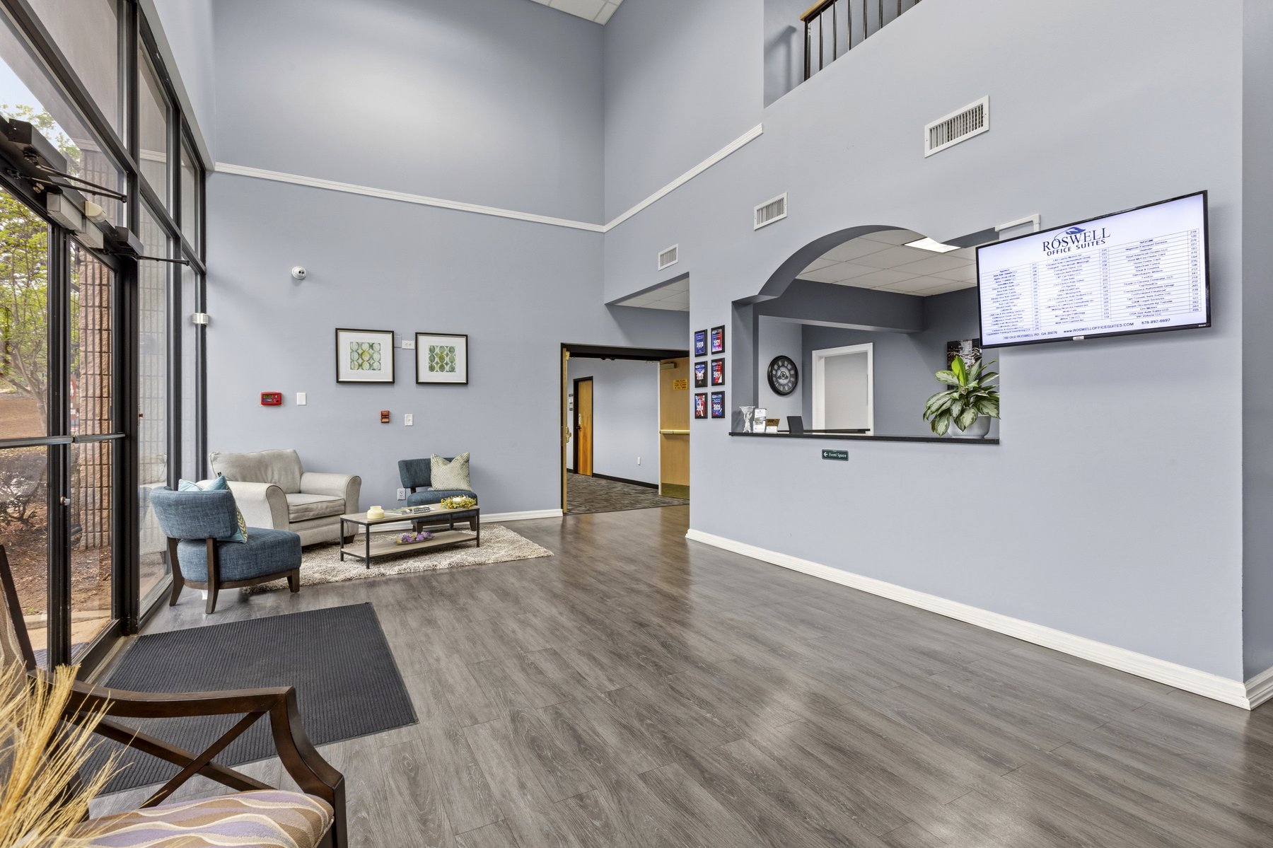 Lobby and reception area at Roswell Office Suites with seating and the tenant directory