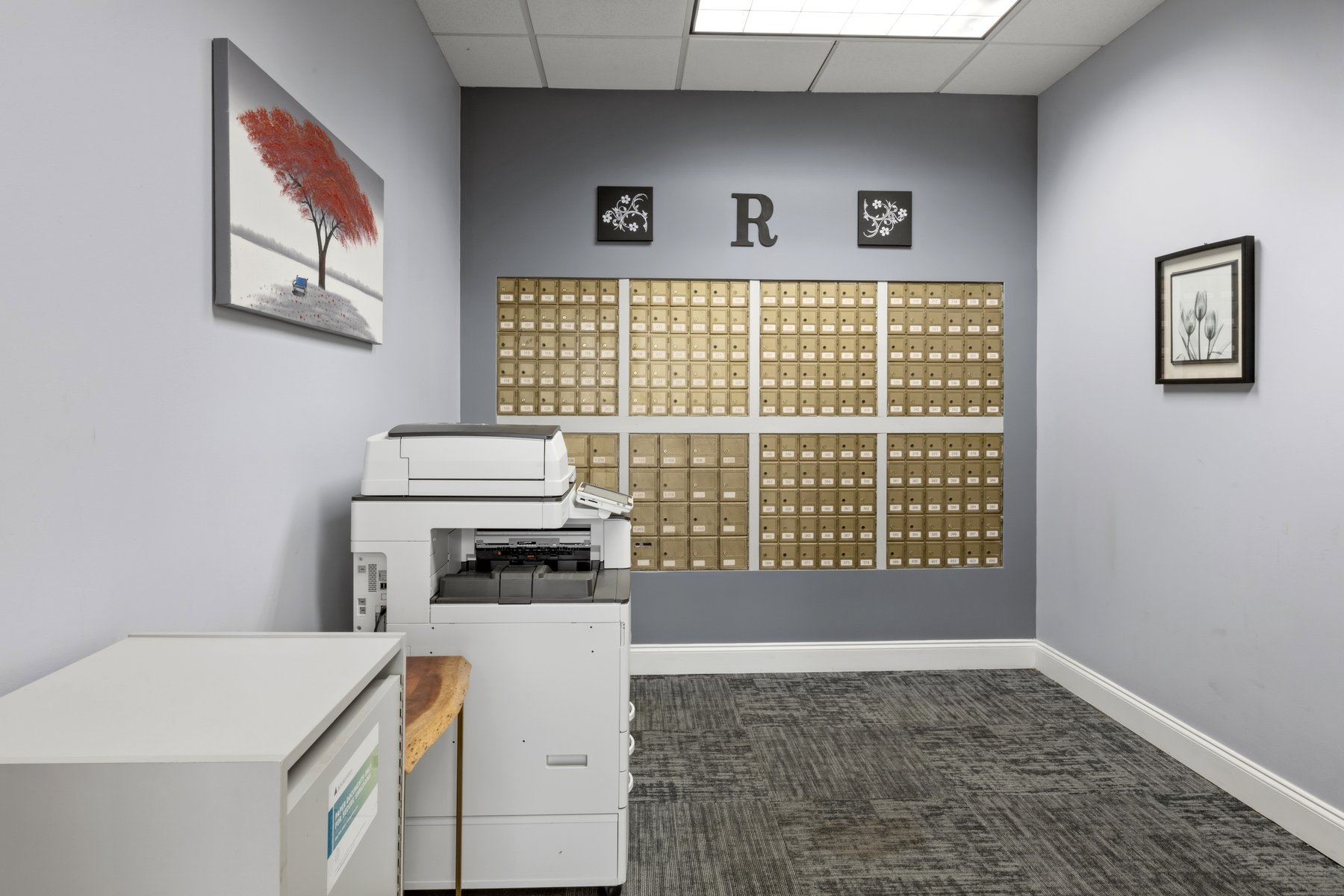 Mail and package area at Roswell Office Suites with tenant mailboxes and copier